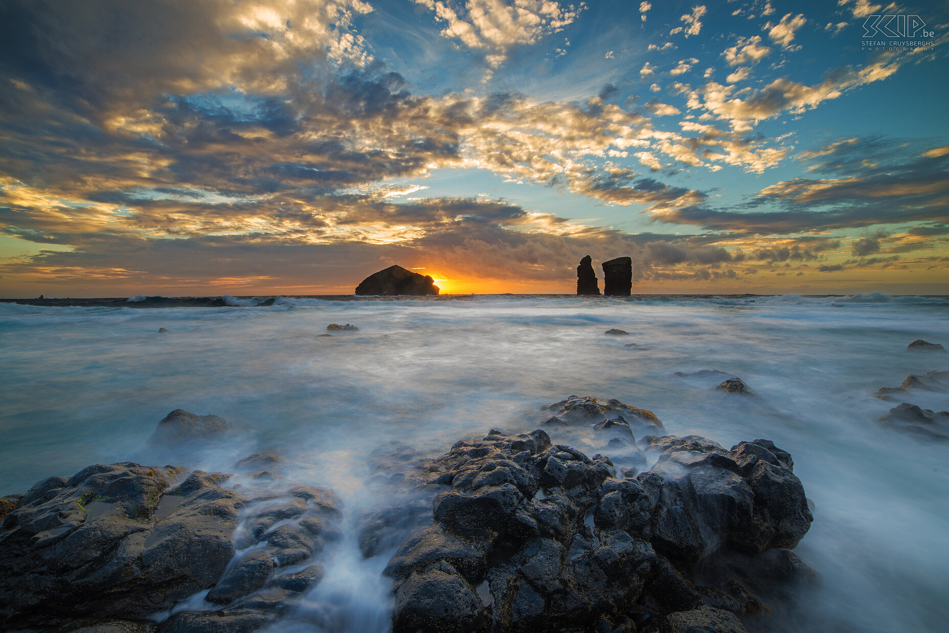 Sunset Mosteiros Sunset at the rocky coast of Moisteros. The village of Mosteiros is primarily recognizable by a group of islets that lie offshore. The word 'Mosteiros', meaning monastery in Portuguese, was named after the largest islet that is shaped like a church. Stefan Cruysberghs